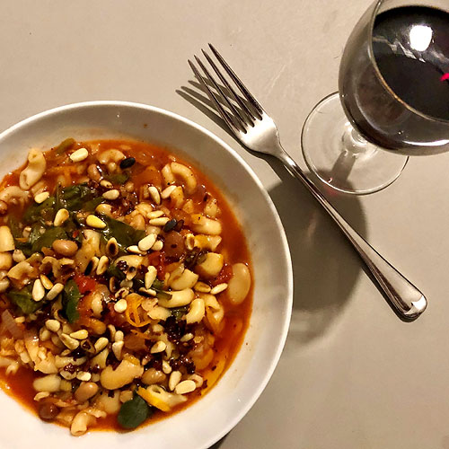 Spinach and Borlotti Bean Minestrone with Macaroni, Chilli Oil and Pine Nuts - Served