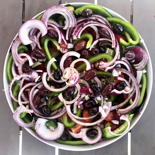 red onions green peppers olives tomatoes salad